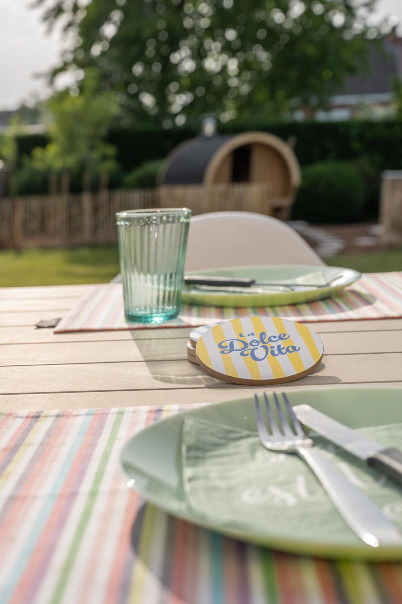 Gedekte buitentafel met zicht op sauna